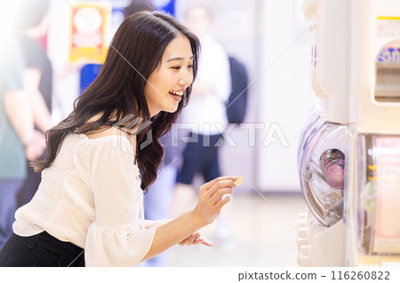 Young woman enjoying capsule toys 116260822