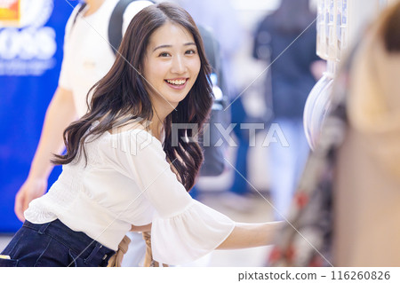 Young woman enjoying capsule toys 116260826