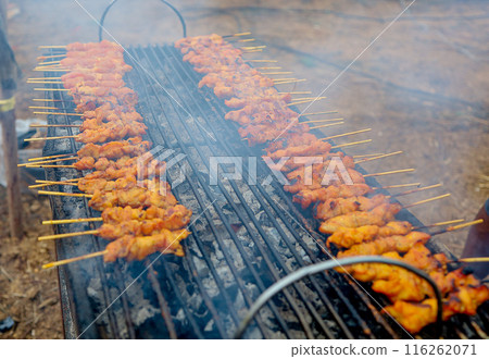 Top view of grilled chicken on a charcoal stove, focus selective Top view of grilled chicken on a charcoal stove, focus selective 116262071
