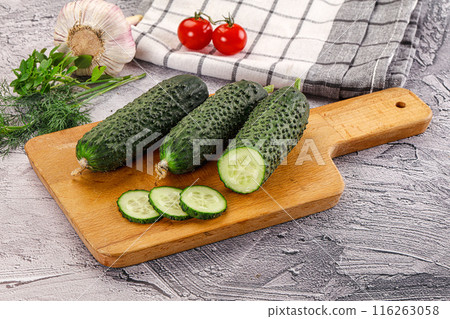 Raw green cucumbers with slices Raw green cucumbers with slices 116263058