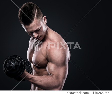 Young man bodybuilder doing exercises with dumbbells 116263956