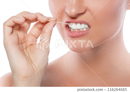 Close up of female teeth and toothpick Close up of female teeth and toothpick 116264085