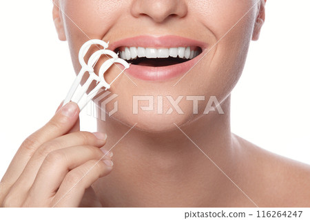 Woman with dental floss pick on white background Woman with dental floss pick on white background 116264247