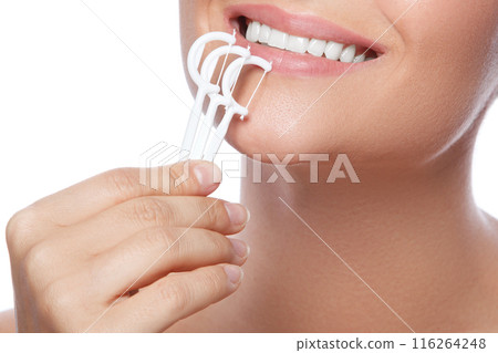 Woman with dental floss pick on white background Woman with dental floss pick on white background 116264248