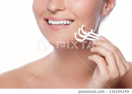 Woman with dental floss pick on white background Woman with dental floss pick on white background 116264249