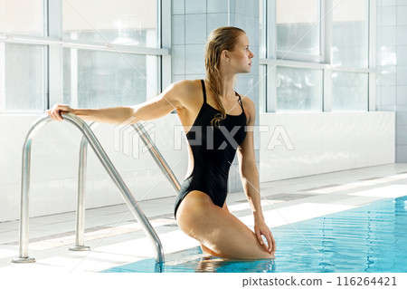 Attractive young woman swimmer on the poolside Attractive young woman swimmer on the poolside 116264421