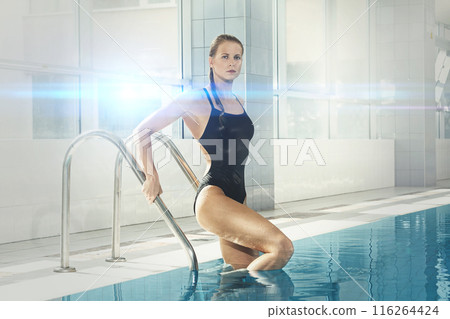 Attractive young woman swimmer on the poolside 116264424