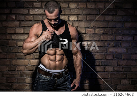 Man with muscular and sexy body against brick wall Man with muscular and sexy body against brick wall 116264668