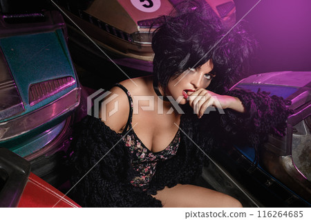 Woman with a cars in the amusement park Woman with a cars in the amusement park 116264685