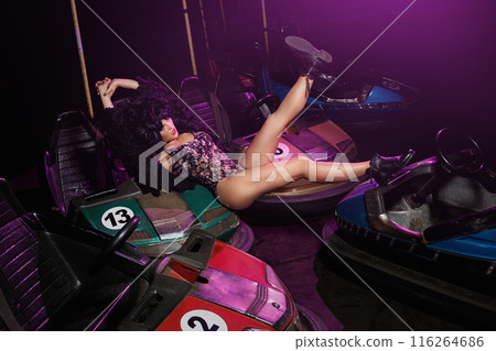Woman with a cars in the amusement park Woman with a cars in the amusement park 116264686