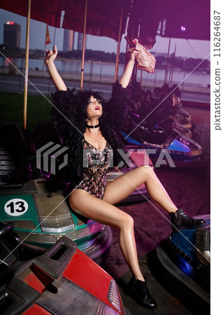 Woman with a cars in the amusement park 116264687