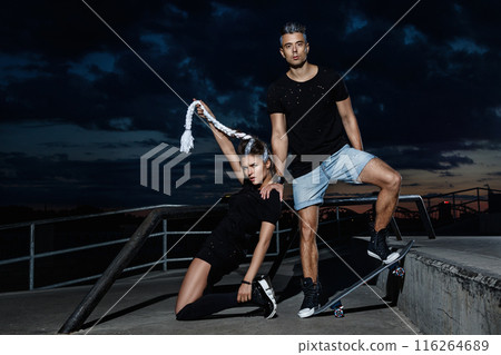 Stylish couple in the skate park at night 116264689