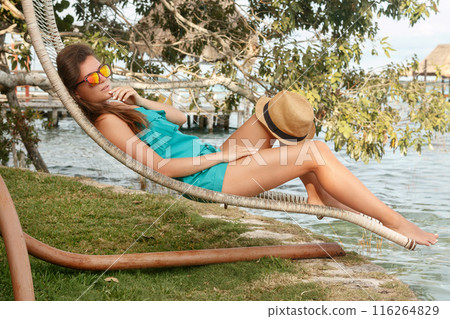 Woman relaxing in sunbed on the lake side 116264829