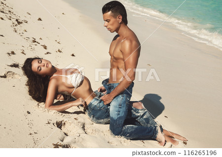 Beautiful couple wearing jeans on the tropical beach 116265196