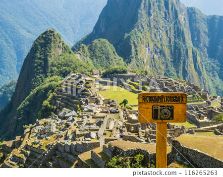 Panoramic viewpoint of Machu Picchu, with wooden photography sign in foreground, Peru 116265263
