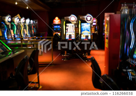 A view of an underground game center with rows of slot machines A view of an underground game center with rows of slot machines 116266038