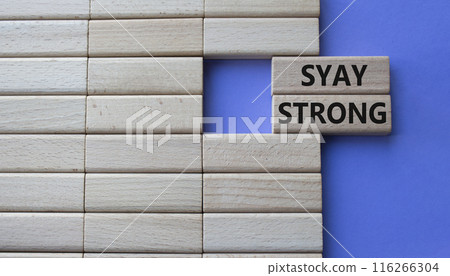 Stay Strong symbol. Concept word Stay Strong on wooden blocks. Beautiful purple background. Business and Stay Strong concept. Copy space Stay Strong symbol. Concept word Stay Strong on wooden blocks. Beautiful purple background. Business and Stay Strong concept. Copy space 116266304