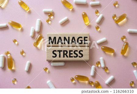Manage stress symbol. Concept word Manage stress on wooden blocks. Beautiful pink background with pills. Medicine and Manage stress concept. Copy space 116266310