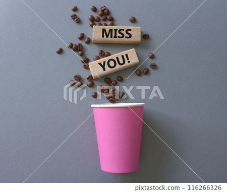 Miss you. Concept word Miss you on wooden cubes. Beautiful grey background with coffee cup. Business and Miss you concept. Copy space. 116266326