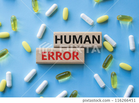 Human Error symbol. Concept word Human Error on wooden blocks. Beautiful blue background with pills. Medicine and Human Error concept. Copy space 116266451