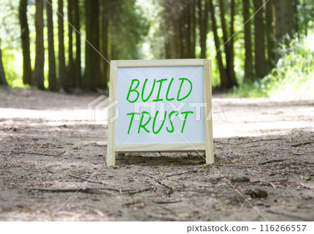 Build trust symbol. Build trust on white chalk blackboard. Beautiful forest background. Business and Build trust concept. Copy space. 116266557