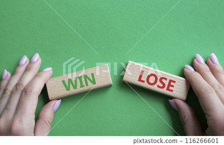 Win or Lose symbol. Concept word Win or Lose on wooden blocks. Businessman hand. Beautiful green background. Business and Win or Lose concept. Copy space 116266601