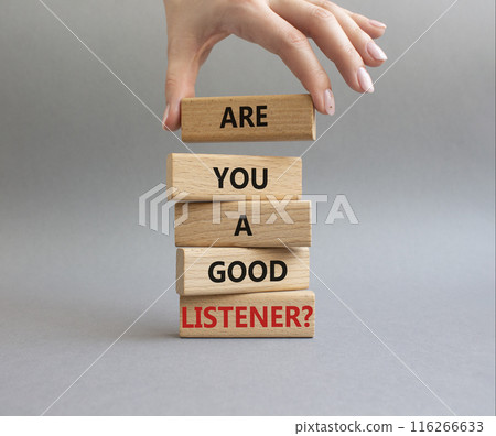 Listening skills symbol. Wooden blocks with words Are you a good Listener. Beautiful grey background. Businessman hand. Business and Are you a good Listener concept. Copy space. 116266633