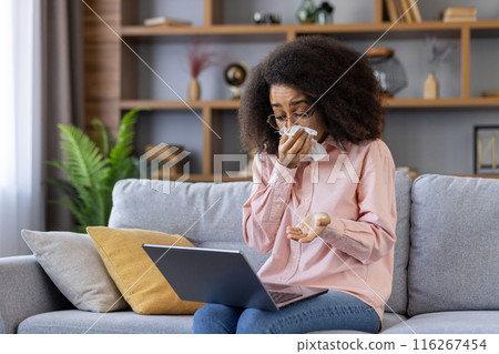 Woman crying during online consultation with psychologist using video call. Emotional moment of virtual therapy session. Shows comfort of home therapy for mental health support. Woman crying during online consultation with psychologist using video call. Emotional moment of virtual therapy session. Shows comfort of home therapy for mental health support. 116267454