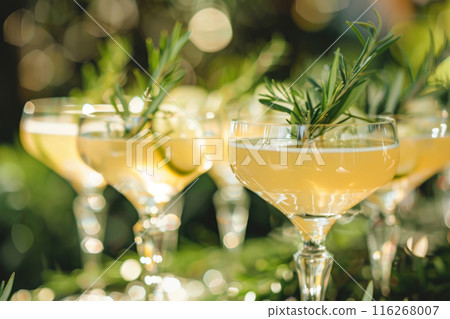 Refreshing summer drinks garnished with fruit and herbs on a rustic wooden surface 116268007