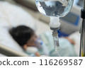 Asian todler in hospital with intravenous saline. Sick children, infected with the virus, are lying and being treated in beds in hospitals. 116269587