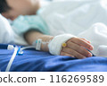 Asian todler in hospital with intravenous saline. Sick children, infected with the virus, are lying and being treated in beds in hospitals. 116269589