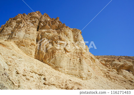 Towering cliffs under a beautiful blue sky 116271483