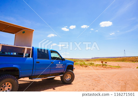 A blue car parked under a blue sky A blue car parked under a blue sky 116271501