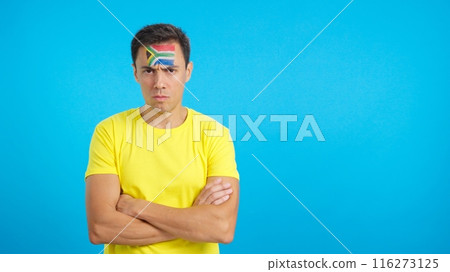 Dignified and serious man with south african flag painted on face 116273125