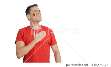 Man listening to the Belgium national anthem with solemnity 116273176