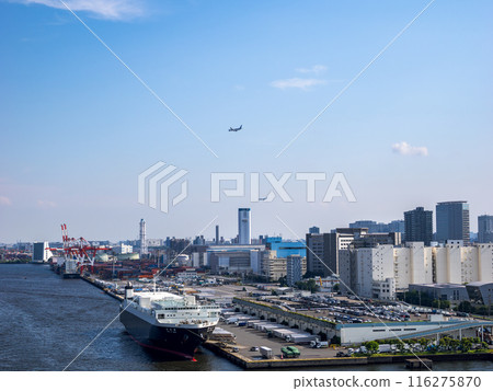 A cargo ship anchored at Shinagawa Pier and a passenger plane landing at Haneda Airport A cargo ship anchored at Shinagawa Pier and a passenger plane landing at Haneda Airport 116275870