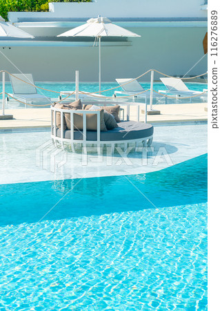 umbrella with bed pool around swimming pool 116276889
