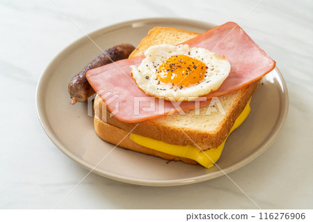 bread toasted cheese topped ham and fried egg with pork sausage 116276906