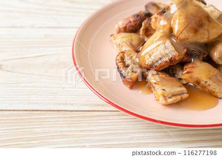 grilled bananas with coconut caramel sauce grilled bananas with coconut caramel sauce 116277198