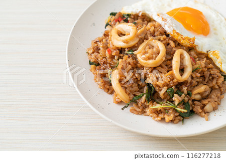 fried rice with squid and basil topped fried egg in Thai style fried rice with squid and basil topped fried egg in Thai style 116277218