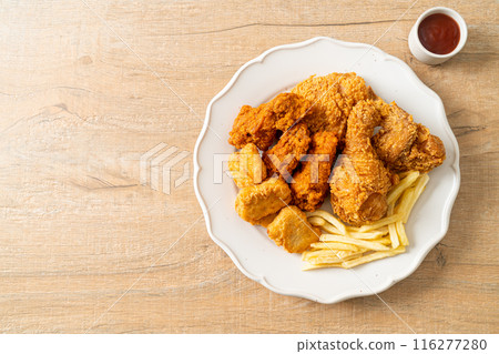 fried chicken with french fries and nuggets on plate fried chicken with french fries and nuggets on plate 116277280