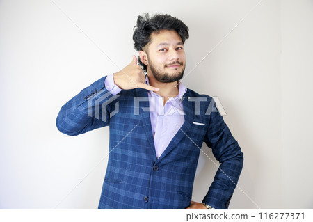 A businessman in a suit posing for a phone call A businessman in a suit posing for a phone call 116277371