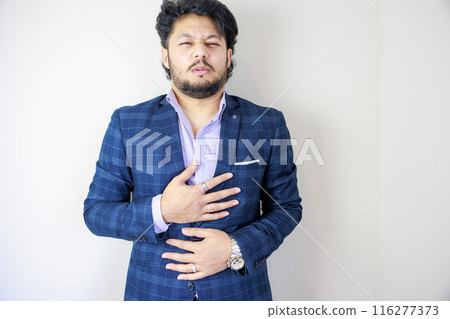 A man in a suit who is unwell 116277373