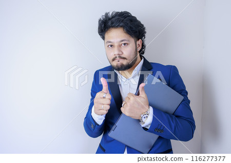A businessman holding a laptop and giving a Good sign 116277377