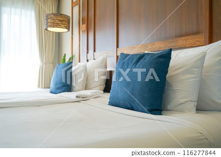 comfortable pillows and white pillows on bed 116277844