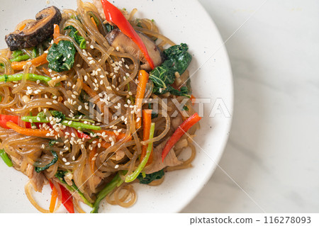 japchae or stir-fried Korean vermicelli noodles with vegetables and pork topped with white sesame 116278093