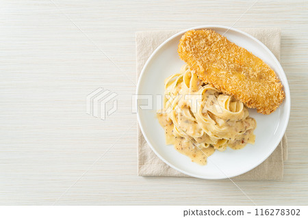 fettuccine pasta white cream sauce with fried fish 116278302