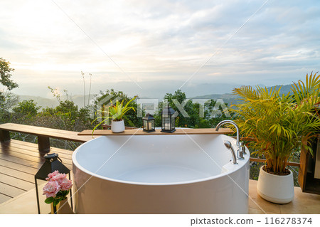 outdoor bath tub with beautiful mountain view background outdoor bath tub with beautiful mountain view background 116278374