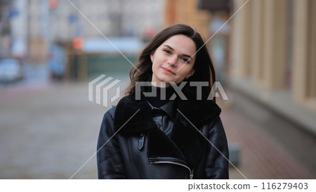urban portrait of a stylish brunette girl in a black jacket urban portrait of a stylish brunette girl in a black jacket 116279403