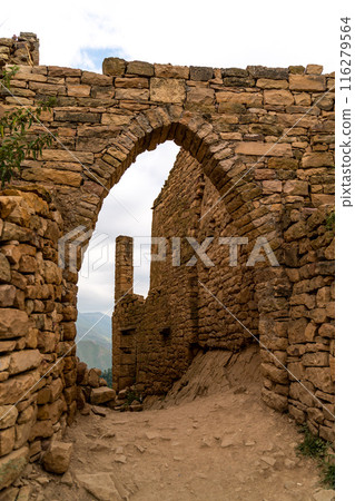A stone archway with a small window in the middle A stone archway with a small window in the middle 116279564